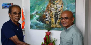 wwf De Federatie van Visuele Artiesten in Suriname (FVAS) en de WWF-Guianas zijn een samenwerking aangegaan om op 10 scholen in Suriname muurschilderingen te plaatsen. Dit, werd verzegeld toen de FVAS een jaguar schilderij van kunstenaar Anand Binda overhandigde aan WWF-Guianas. Op de muur zal de jaguar worden geschilderd. Op deze wijze wil men de aandacht vragen voor betere bescherming van de bedreigde Jaguar. Deze katachtige is beschermd in ons land, maar staat steeds meer onder druk door stroperij en verlies van leefgebied door onder meer goudwinning, mijnbouw en houtkap. Suriname heeft met de ondertekening van de Jaguar Roadmap 2030 toegezegd de jaguar beter te beschermen. Maar de voorgestelde maatregelen, zoals meer beschermde gebieden moeten nog worden uitgevoerd. Bescherming Om mensen bewust te maken van het belang van de jaguar, moeten we ze in het hart raken,” vertelt Binda, initiatiefnemer van het kunstproject. “Kunst doet dat. Ik geloof dat de muurschilderingen van kinderen op hun scholen en hun boodschap over de noodzaak van bescherming van de jaguar, mensen ook in het hart zal raken.” Het voorgenomen kunstproject “Jaguar a konu fu a busi”, maakt deel uit van breder jaguar programma dat WWF-Guianas momenteel uitvoert, samen met partners in de nieuwe Nationale Jaguar Werkgroep Suriname (NJWS). Daarin werkt WWF-Guianas samen met Amazon Conservation Team (ACT) Suriname, CI-Suriname en het Herbarium en de National Zoological Collection of Suriname (NZCS) van de Anton de Kom Universiteit. Onderzoek Gezamenlijk doen zij op zes locaties in Suriname onderzoek naar de jaguar populatie: Curuni, Sipa, Bigi Poika, Natuurpark Peperpot, Brownsberg en Galibi. Dit gebeurt onder meer met cameravallen, die maken een foto als de jaguars passeert, of een dier waar jaguars op jagen. Daarnaast wordt de vegetatie in de leefgebieden in kaart gebracht en wordt aan bewoners van inheemse gemeenschappen gevraagd hoe zij samenleven met de jaguars in hun omgeving. Binnen het project wordt nauw samengewerkt met inheemse gemeenschappen. Met de uitkomsten van het onderzoek willen de organisaties pleiten voor betere beschermingsmaatregelen. Het kunstinitiatief “Jaguar a konu fu a busi”, moet daarbij helpen door het bewustzijn over jaguar bescherming te vergroten. De grote muurschilderingen die mogelijk binnenkort al op diverse scholen verschijnen hebben daarom een aansprekende boodschap over het belang van jaguar bescherming. Bewustwording “Kunst is de ziel van de samenleving”, aldus George Struikelblok, voorzitter van de FVAS, over de samenwerking met WWF-Guianas. “Het verbindt ook mensen met de natuur. En kinderen zijn het beste vertrekpunt wil je een bewustwording op gang brengen.” David Singh, directeur van WWF-Guianas, zegt geïnspireerd te zijn door de samenwerking met de kunstenaars. “Het geeft ons jaguar programma een boost om mensen en regeringsleiders te bereiken en uiteindelijk het commitment te krijgen voor de uitvoering van de Jaguar Roadmap 2030.” Anna Mohase, projectleider bij WWF-Guianas van het jaguar programma: “Deze bijzondere samenwerking brengt niet alleen wetenschappers en NGO’s samen, maar ook organisaties zoals de FVAS en hopelijk het ministerie van Onderwijs. Daarmee komt het project om de jaguar beter te beschermen daadwerkelijk tot leven in Suriname.”