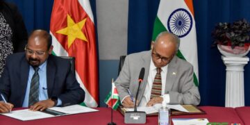 De Indiase ambassadeur voor in India in Suriname en BIBIS minister Albert Ramdin ondertekenen een vijftal overeenkomsten De Indiase ambassadeur voor India in Suriname en BIBIS-minister Albert Ramdin geven elkaar een handdruk na de ondertekening van een vijftal overeenkomsten.