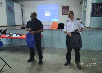 two men standing in a room with a projector screen