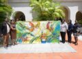 df84fcda c116 47a7 b9e6 8634564335a4 1536x1024 1 De Surinaamse delegatie die deelneemt aan Carifesta XV op Barbados heeft een beleefdheidsbezoek gebracht aan premier Mia Amor Mottley. Tijdens de ontmoeting werd een speciaal vervaardigd canvas schilderij van kunstenaar George Struikelblok officieel aan de premier aangeboden...