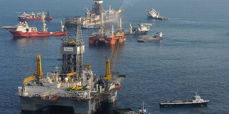 GULF OF MEXICO - The mobile offshore drilling unit (MODU) Development Driller II (near) is prepared to drill a relief well at the Deepwater Horizon site on May 18, 2010, while the MODU Q4000 holds position directly over the damaged blowout preventer. While the drillship Discover Enterprise (far) continues to capture oil from the ruptured riser, preparations for the possible use of a “junk shot” or the “top kill” method are underway aboard the Q4000. U.S. Coast Guard photo by Petty Officer 3rd Class Patrick Kelley.