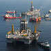 GULF OF MEXICO - The mobile offshore drilling unit (MODU) Development Driller II (near) is prepared to drill a relief well at the Deepwater Horizon site on May 18, 2010, while the MODU Q4000 holds position directly over the damaged blowout preventer. While the drillship Discover Enterprise (far) continues to capture oil from the ruptured riser, preparations for the possible use of a “junk shot” or the “top kill” method are underway aboard the Q4000. U.S. Coast Guard photo by Petty Officer 3rd Class Patrick Kelley.